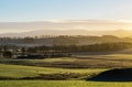 Misty rural highlands landscape in sunrise light Royalty Free Stock Photo