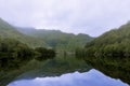 Misty and serene landscape of a lake and mountains in the Highlands of Scotland, United Kingdom Royalty Free Stock Photo