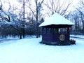 Shelter in the middle of a snowy forest park.