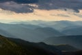 Misty spring mountain hills landscape. Layers of green mountains and hills in the haze during sunset. Royalty Free Stock Photo