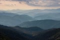 Misty spring mountain hills landscape. Layers of green mountains and hills in the haze during sunset. Royalty Free Stock Photo