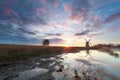 Misty sunrise behind Dutch windmill Royalty Free Stock Photo