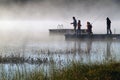 Misty sunrise fishing on lake Royalty Free Stock Photo