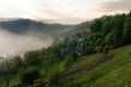 Misty sunrise on forest hill village