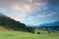 Misty sunrise over alpine meadows by Geroldsee lake