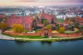 Misty sunrise over the Malbork castle and Nogat river in Poland Royalty Free Stock Photo