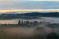 Misty sunrise over Tuscan country house