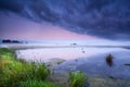 Misty sunrise over wild lake