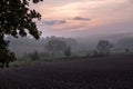 misty sunset, plowed field, red clouds, landscape