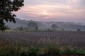 misty sunset, plowed field, red clouds, landscape