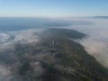 Misty trees from above. Aerial view of Morning fog and sunrise in autumn. Beautiful romantic atmosphere in landscape. Summer time Royalty Free Stock Photo