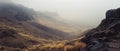 Misty valley between rugged mountain slopes Royalty Free Stock Photo
