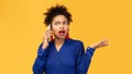 Upset young afro woman talking on mobile phone Royalty Free Stock Photo