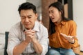 Misunderstanding in relations. Asian woman blaming husband and shouting at man, spouses suffering marriage crisis