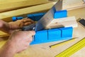 Miter box and hacksaw for sawing wooden parts