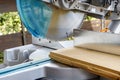 Miter saw in the process of sawing off a wooden part Royalty Free Stock Photo