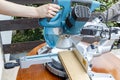 Miter saw in the process of sawing off a wooden part Royalty Free Stock Photo