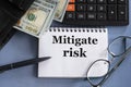 MITIGATE RISK - words in a notebook against the background of money, glasses and calculator Royalty Free Stock Photo