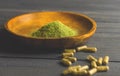 Mitragynina speciosa or Kratom powder in wooden bowl and Kratom pills