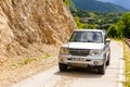 Mitsubishi Pajero iO 4x4 off-road car driving on a gravel road to Khvamli Mountain peak, Georgia Royalty Free Stock Photo