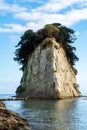 Mitsukejima diamond shaped island with plants and trees on top of the rock on Noto Peninsula, Japan, portrait view.