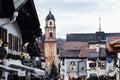 MITTENWALD, GERMANY - DECEMBER 2018: roofs of old town with church of St. Peter and St. Paul tower in the center