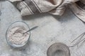 Mix for baking with bird cherry flour in a transparent bowl on a concrete tabletop background. Culinary cover, ingredient