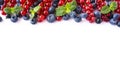 Mix berries and fruits at border of image with copy space for text. Ripe blueberries, blackberries, strawberries, red and black cu Royalty Free Stock Photo