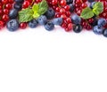 Mix berries and fruits at border of image with copy space for text. Ripe blueberries, red and black currants on white background. Royalty Free Stock Photo