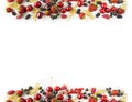 Mix berries and fruits at border of image with copy space for text. Ripe cherries, strawberries, currants and mulberrieson white b Royalty Free Stock Photo