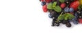 Mix berries on a white background. Berries and fruits at border of image with copy space for text. Black-blue and red food. Ripe b Royalty Free Stock Photo