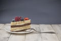 Mix berry cheese cake on white plate on wood background Royalty Free Stock Photo