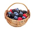 Mix of blackberry blueberry raspberry black currant in wicker basket isolated on white background. Royalty Free Stock Photo