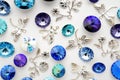 Blue and purple crystals and metal bees and flowers and dragonflies on white background Royalty Free Stock Photo