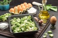 Mix broccoli and Brussels sprouts in food metal pallet. Eggs, garlic and onions, flour and butter in bottle Royalty Free Stock Photo