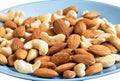 Mix of cashew and almond nut on blue plate Royalty Free Stock Photo