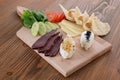 Mix cheese with tomato, cucumber and pita bread served in wooden board isolated on table side view of arabic food Royalty Free Stock Photo