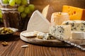 Various types of cheeses on a wooden board Royalty Free Stock Photo