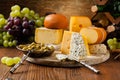 Various types of cheeses on a wooden board Royalty Free Stock Photo