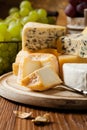 Various types of cheeses on a wooden board Royalty Free Stock Photo