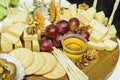 Mix cheese on wooden board with grapes. Front view. Royalty Free Stock Photo