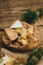 Mix cheese on a wooden board with herbs. Royalty Free Stock Photo