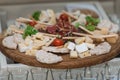 Mix cheese on wooden board with meat and bread Royalty Free Stock Photo