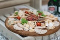 Mix cheese on wooden board with meat and bread Royalty Free Stock Photo