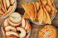 Mix of chips, snacks and crackers on a wooden stand. Unhealthy food, beer snack, ready meal. Close Up Royalty Free Stock Photo