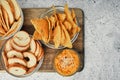 Mix of chips, snacks and crackers on a wooden stand. Unhealthy food, beer snack, ready meal. Close Up Royalty Free Stock Photo