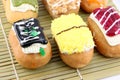 Mix color Sushi Donuts in bamboo dish. Royalty Free Stock Photo