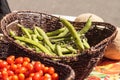 Mix of colorful cherry tomatoes and string beans in baskets Royalty Free Stock Photo