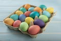 Mix of colorful chicken eggs in a carton