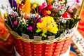 Mix of colorful spring flowers in a braided wicker basket